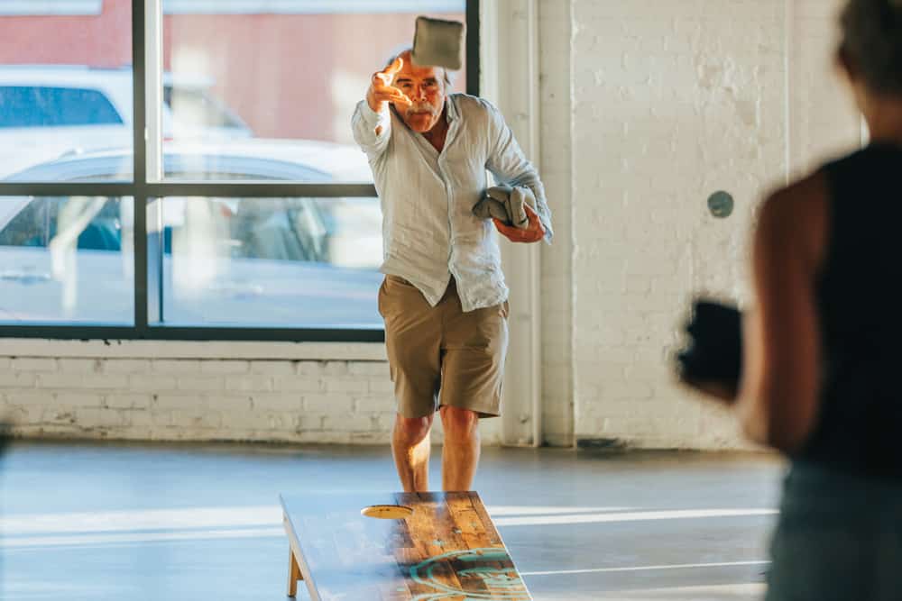 A man playing cornhole indoors